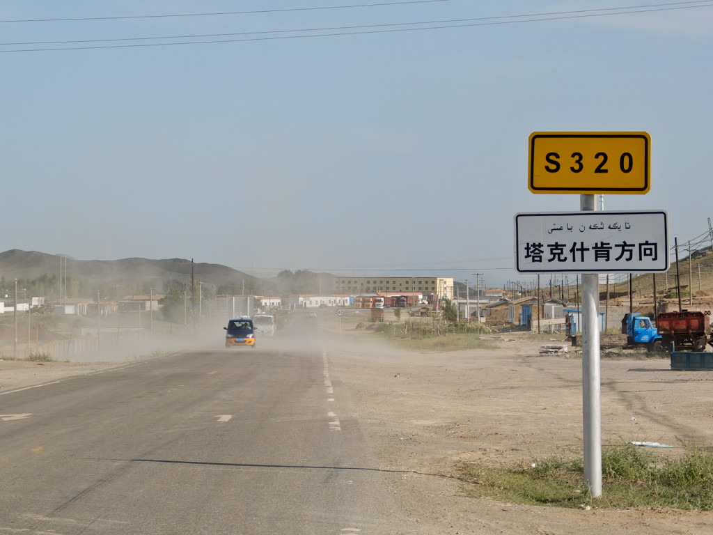Near Qinggil, Xinjiang Province: The landscape changed dramatically as we approached the Mongolian border. You can also see Arabic text on the road signs. It is common in China to see the minority language present on the street signs.